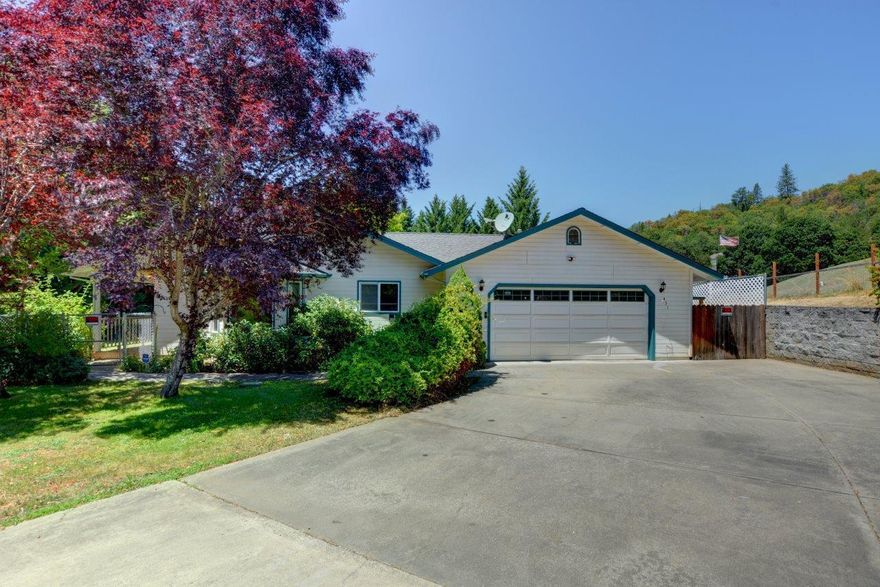 Discover the perfect blend of comfort and convenience in this wonderful home that  sits on a spacious .41 lot. This 1384 ft.² home features two bedrooms and two full baths  with the primary bedroom offering a large walk-in closet.  The  living room, dining room, and kitchen have  a beautiful wood ceiling, giving you a cozy living space. The open floor concept is inviting and features a large laundry room with utility sink and lots of storage This charming Home is nestled at the end of a quiet street and just moments from town. Enjoy the beautiful spacious landscaped yard with plenty of room for a garden. The property has five garages/workshops perfect for all your projects and offers ample space for hobbies and storage needs . This home offers great potential with a little bit of improvement and you can't  miss the large covered patio perfect for entertaining. Schedule your private showing today.