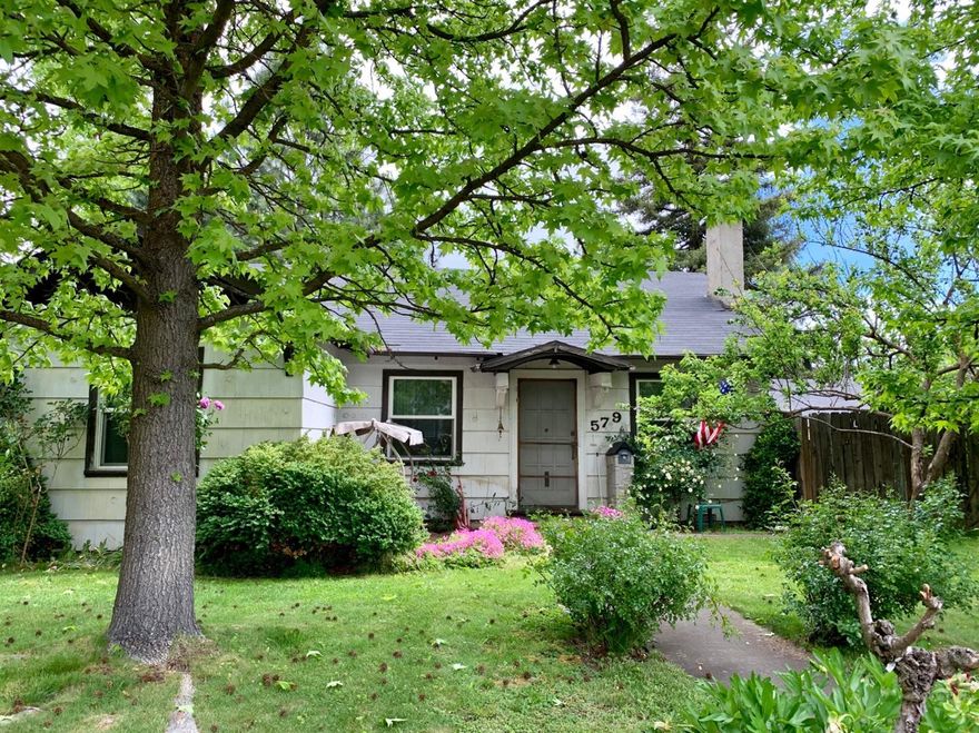 Cute 2 bedroom, 1 bath home, living room with gas fireplace, dining room and kitchen, Laundry on the back enclosed porch. Huge yard with possibility for ADU per the City of Medford. Large garage/shop/barn area. This home sits on a corner lot with apple, persimmon, fig, plus & cherry trees. There is lots of potential with love & care, repairs and updating to this home. Cash Only or conventional but needs TLC.
