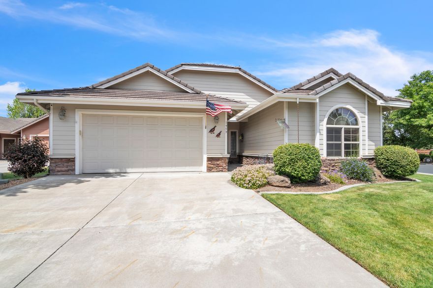 Charming one-level home in a gated community, featuring vaulted ceilings and a spacious layout with 3 bedrooms. The primary suite offers a cozy fireplace, double sinks, and a large bathroom. Enjoy wall-to-wall carpet throughout, with linoleum/vinyl flooring in the kitchen, dining room and laundry and wood flooring in the entry. The kitchen includes built-in appliances, a pantry, and plenty of storage. A separate laundry room offers additional cabinetry and a utility sink. Step outside to a covered patio, expansive yard, and garden—perfect for outdoor living. Recent upgrades include a new A/C, furnace, and water heater.