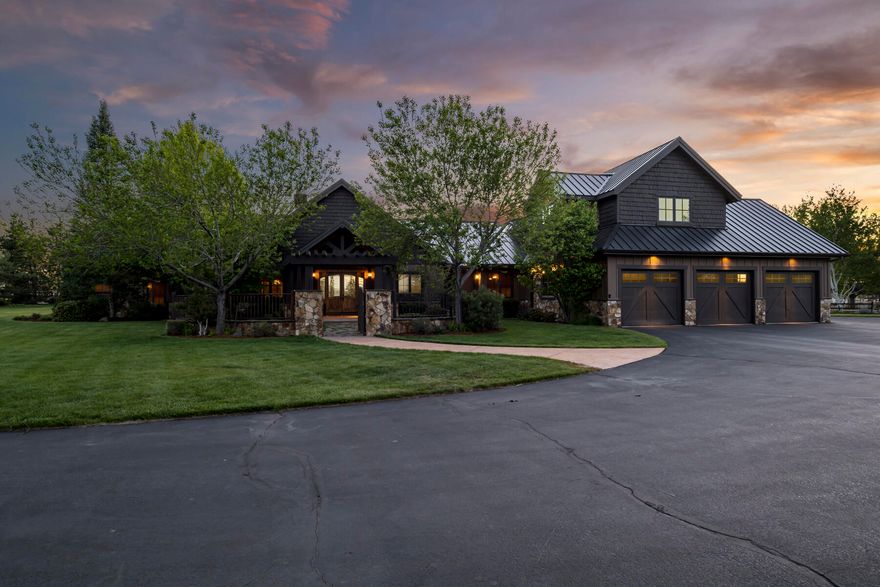 Nestled in the heart of Tumalo Oregon, this rare property spans 9.28 acres of manicured landscape and is accessed through a private entrance gate. The custom Northwest Home boasts stunning views of the Cascade Mountains and Cline Butte. The property features a pond, an expansive covered concrete patio, a stream flowing to your own 1.25-acre private lake with a dock, and a courtyard with a stone and iron gated entrance leading to the main house. Upon entering the front doors, a vaulted foyer with exposed beams welcomes you into the Great Room. The main house includes a private master wing, a library area or second office, 4 generously sized bedrooms, a 5th bedroom or gym space, a large mudroom, and a bonus room upstairs with a private deck. Additionally, there is a 2500 sq ft shop that includes a 912 sq ft private guest quarters. Only the highest exquisitely finished materials are used inside and outside, offering a true retreat to enjoy that's not too far from city amenities.