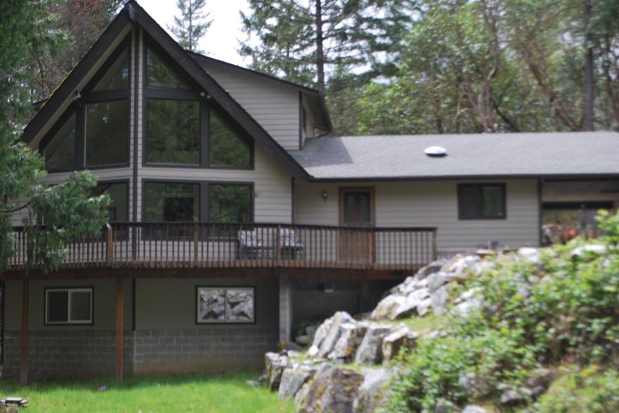 Beautiful peaceful and convenient is just part of what makes this Chalet style home a must see. Take in the natural light and views from the large front windows by day and the fire in the comforting wood stove at night. The large deck will be great for entertaining summertime guests. The kitchen has an island, and is open concept living space with family room. The daylight basement has an amazing space that can be used as a game room, hobby room, play room, or whatever your imagination brings to it. Plenty of work space in oversize garage with full bath. Plenty of parking and turnaround space for your guests and RV parking. The RV pad has its own electric and septic hookups. All information deemed accurate but not guaranteed and subject to change at any time.