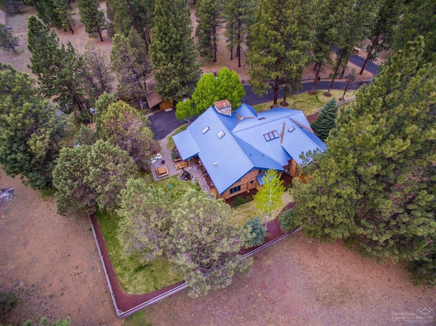 The spirit of the West lives on in Sisters Country! Capture the legacy of centuries-old log craftsmanship while providing a modern context for luxury High Desert living in this custom home. Vaulted interiors with skylights & plentiful windows blur the line between the indoors and out. Main level master suite provides sought after comfort while versatile entertaining spaces accommodate friends & family. Australian cypress hardwood floors, floor-to-ceiling river rock fireplace, & impressive timbers make this home exceptional. The gated, wooded setting is complete with storage building, 2-stall barn, & full RV hookups. There is no need to compromise on location here! Not only are you just minutes to burgeoning Downtown Sisters, the beauty of public lands await your exploration at the end of the block. Come experience the perfect balance of in-town proximity & forested seclusion! Harmony awaits!