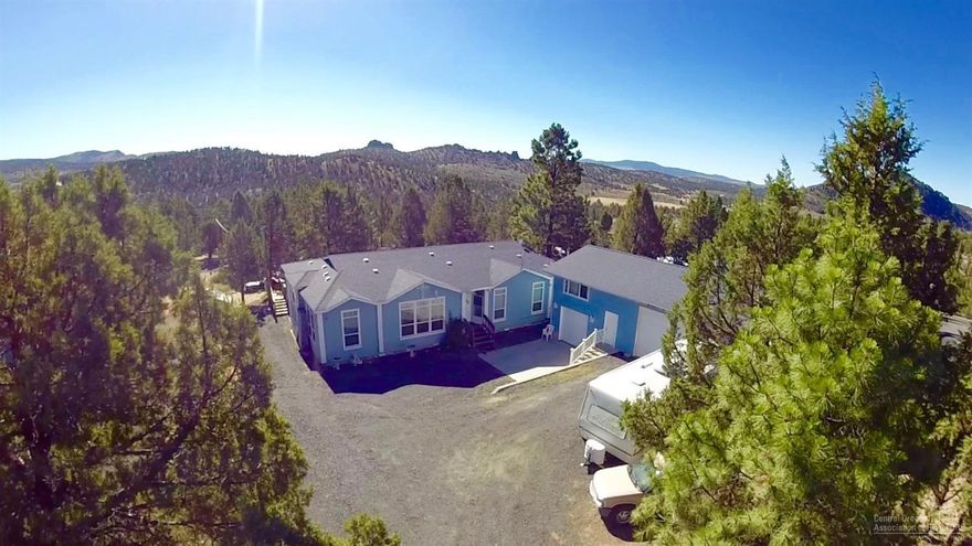 Beautiful large home with garage and shop on over a half acre within minutes of Prineville Reservoir. Home features an appealing floor plan w/a living room & family room, formal dining, breakfast nook w/french doors to a large deck, gorgeous kitchen, huge master bedroom w/french doors & private den that is perfect for an office or exercise room, master bath has a soaker tub, walk in shower & his and hers vanities. Outside you will find a garage w/tons of above storage & a large two bay shop w/wood stove.
