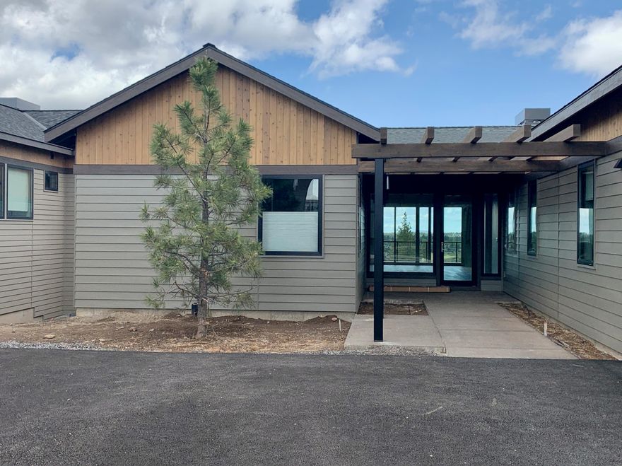 This enclave of homes built by BendTrend is quickly taking shape and is poised to be a premier neighborhood within the Tetherow community. This homesite features a single-level Dutchman plan with 4 bedrooms plus a den and an oversized 2-car garage. Luxury finishes and craftsmanship throughout include hardwood floors in the main living areas, quartz countertops in the kitchen and bathrooms, and tiled showers and floors in the bathrooms. The walkout deck off the back of the home overlooks the Deschutes National Forest with Cascade Mtn view and features both covered and sunny outdoor entertaining spaces. Direct access to Phil's Trail system for mountain biking and hiking is just out your back door and the community is across from the Tetherow pool, fitness center, dining, and golf course. Social membership initiation fee is included. These private residences may not be used as vacation rentals.