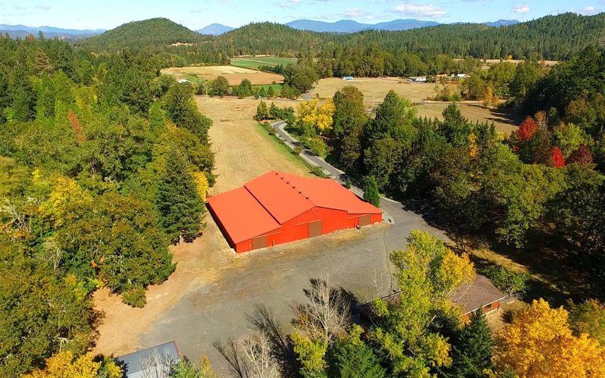 Beautiful 24 ac pastoral ranch in the Applegate Valley with 15 acres of water rights and year round Cheney Creek running its western flank. The property is a perfect equestrian refuge with remodeled single level ranch home, massive 8 stall horse barn with indoor riding arena. Lush Fenced and cross fenced pastures encompass the ranch house that is set back form the road and give the home exclusive privacy with gated entry. There are beautiful yards and pasture behind the residence. There is a very large shop 42x40 with three stalls for RV parking and a detached 4 car garage with lovely guest suite. Water rights of this property are from a scenic pond and a well. The barn has well lighted riding arena and ample storage rooms for equipment and hay and tack room. The ranch home is single level with 3 bedrooms 2.5 bathrooms with two large bonus rooms. The kitchen has been remodel and new hardwood floors throughout. There is a very large dining/entertaining room and comfortable living room.