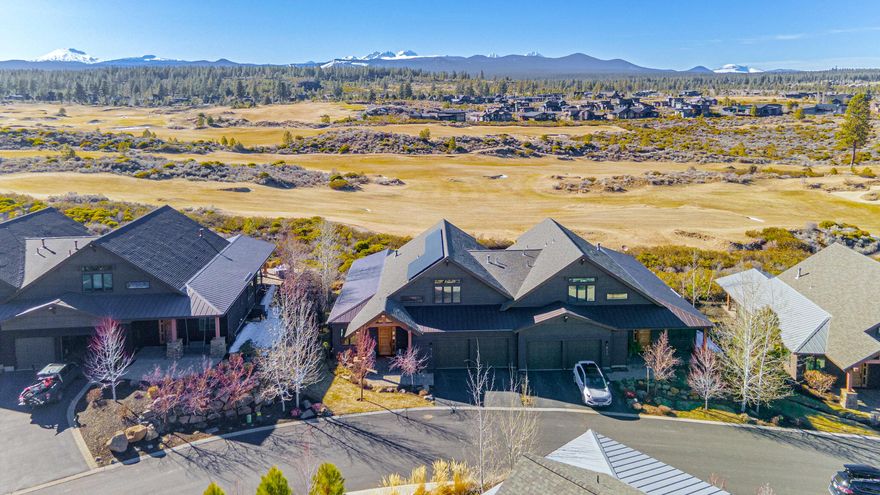 With one of the most coveted locations in Triple Knot, this stunning townhome offers a private setting and exceptional views encompassing the Cascade Mountains, Tetherow golf course, and the sprawling natural landscape. Floor to ceiling windows in the vaulted great room frame the view and provide abundant natural light. The refined kitchen boasts Thermador appliances, wine fridge, and double islands. Wake up to a view from the main-level primary suite and spa-like bath featuring a heated floor, soaking tub, and tiled shower. The floor plan also includes a main floor office plus two en-suite bedrooms upstairs. Electric shades around the covered patio offer privacy and sun protection and the owned solar electric system installed in late 2023 is sized to produce 125% of home's annual electricity use. With world-class golf, immediate access to hiking and biking trails, and Mt. Bachelor just 18 miles away, the access to recreation is hard to beat. This isn't just a home, it's a lifestyle.
