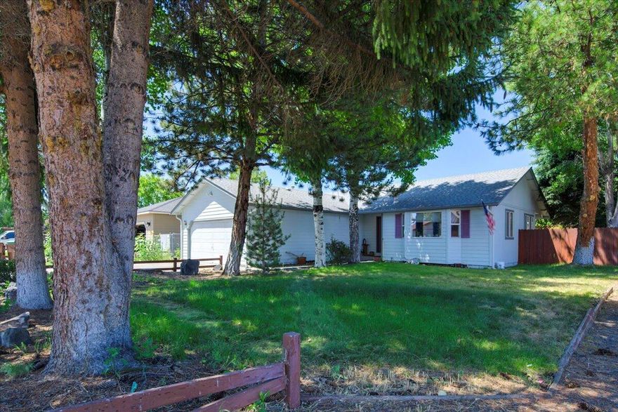 Welcome to your cozy corner of Prineville! This charming single-level home is the perfect starter space, tucked beneath the shade of beautiful mature trees. Inside, enjoy a practical layout with just the right amount of space to make your own. Step out back to a fully fenced yard—ideal for your furry friends, backyard games, or peaceful evenings under the trees. A small garden spot is ready for your tomatoes, sunflowers, or whatever green things make you smile. Located near everyday essentials, this home keeps life simple and sweet. Whether you're planting roots or simplifying life, this one is a solid place to start.