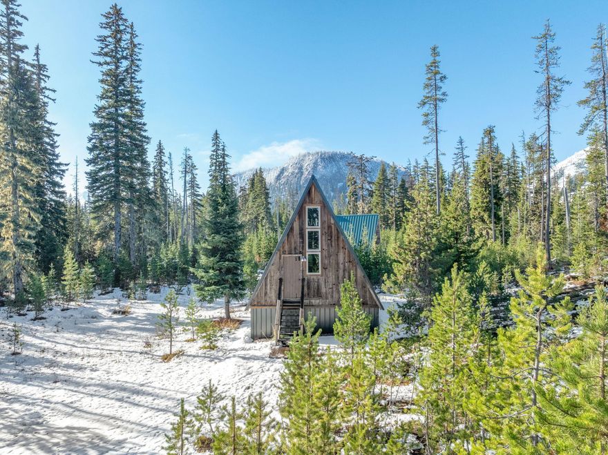 Tucked among the trees near Hoodoo Ski Resort, Cabin 8 is a charming A-frame filled with warmth and history. Built in 1965 by a group of university professors, this cabin has been lovingly cared for by only two owners and radiates the coziness of a true mountain retreat. Inside, you'll find soaring ceilings, wood interiors, and a wood-burning fireplace at the heart of the home. The cabin features new windows, a new roof, and comes fully furnished—ready for winter weekends or year-round escapes. The upper level offers additional sleeping space beneath the eaves, while the lower level provides plenty of storage for skis, gear, and adventure essentials. Located close to Hoodoo Ski Resort, this rare find includes electricity and approval for up to three buildings, offering endless potential for expansion or a multi-cabin compound. Whether you're seeking a basecamp for mountain fun or a quiet hideaway under the pines, Cabin 8 is ready to welcome its next chapter. All offers by 10/18 @5pm