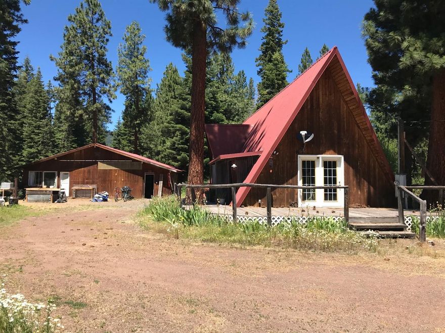 Over 9 acres in Rocky Point! Enjoy this peaceful secluded setting! This home sits right in the heart of some of the best hunting and fishing! Very well kept A frame with natural wood interior, this home is comfortable for year-round living or would make a great vacation get away! Large loft for additional bedroom and living area. Large deck for summer BBQ's. This property boarders forest service on 2 sides with 4 mile creek in the back. A seasonal creek runs through the front part of the property, and there are 2 wells. Also included is a 40X40 Shop, 40X30 Barn with electricity and water and a riding arena!