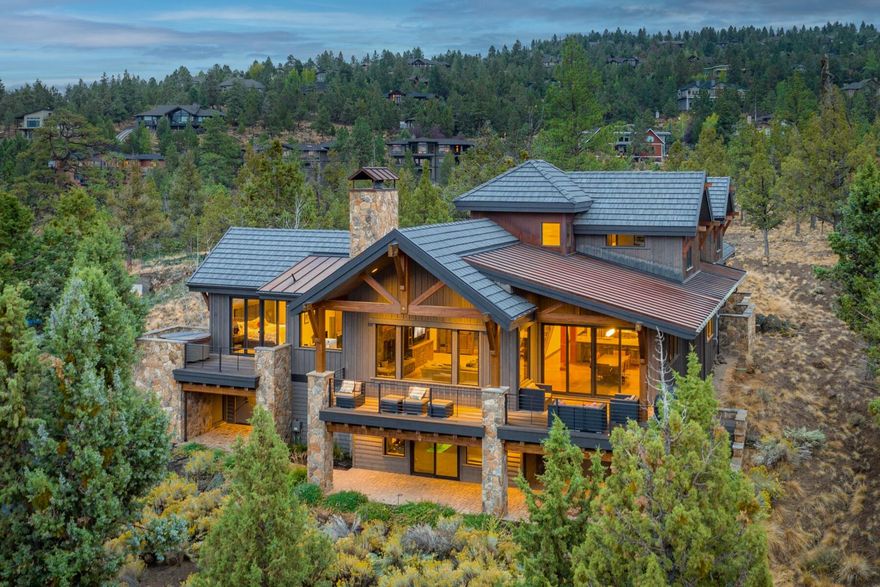 Welcome to North Rim, a neighborhood known for its rugged beauty, convenient Westside location, and where homes blend into their surrounding landscape. This home is perched on the back of a peaceful 1-acre lot, taking full advantage of the long-ranging mountain views. Boasting nearly 3800 sq ft of elegant Northwest warmth, this home maintains a timeless feel and versatile layout. Livability is maximized with an office, spacious and private primary suite, and open concept great room with soaring ceilings, access to outdoor space, and a chef-worthy kitchen. Upstairs, find a roomy guest suite, additional living space, two bedrooms, and a shared hall bath. The downstairs is currently a fitness enthusiast's delight, and with a full bath offers endless versatility. Whether it's indoors with friends or family or on the deck enjoying an epic sunset, this home was made for making memories and we invite you to schedule your tour today.