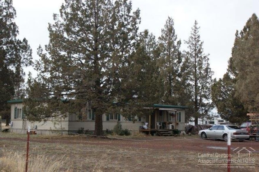 Over 2 acres convenient to Sisters or commute to Bend. Build new frame home/modular, or remove manufactured home and your land value includes water and power. Septic permit 1983, pumped 12/30/15. CCR's allow horses and cattle. Roof 2007 +/-, Quadra Fire woodstove 2008. Monthly tenant $850 wants to stay.