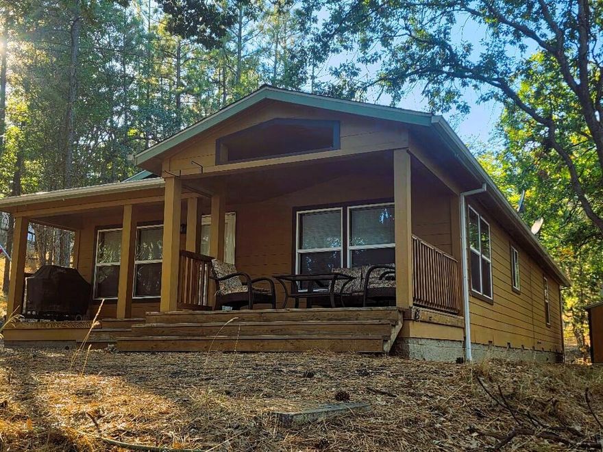 Pine Hollow Gem nestled on private wooded half acre lot with Lake View. Warm & inviting home immaculately maintained. 3Bd/2bth 1500+ SF. Vaulted ceilings, Knotty Pine doors, cabinets & trim. Kitchen Island & Pantry. Dining room. Mudroom. Spacious Master Suite. Windows look out on woods everywhere. Covered porch. Dead End location 1 block from Lake Access. Updated carpet w/ memory foam pad. Dual sinks in Master Bath. Heat Pump. Longitudinal steel support. Oak Mantel Wood Burning FP. Popular Air BnB Rental option, or quiet secluded full time or getaway home. Motivated Seller! Life is better at the lake. Move in ready!