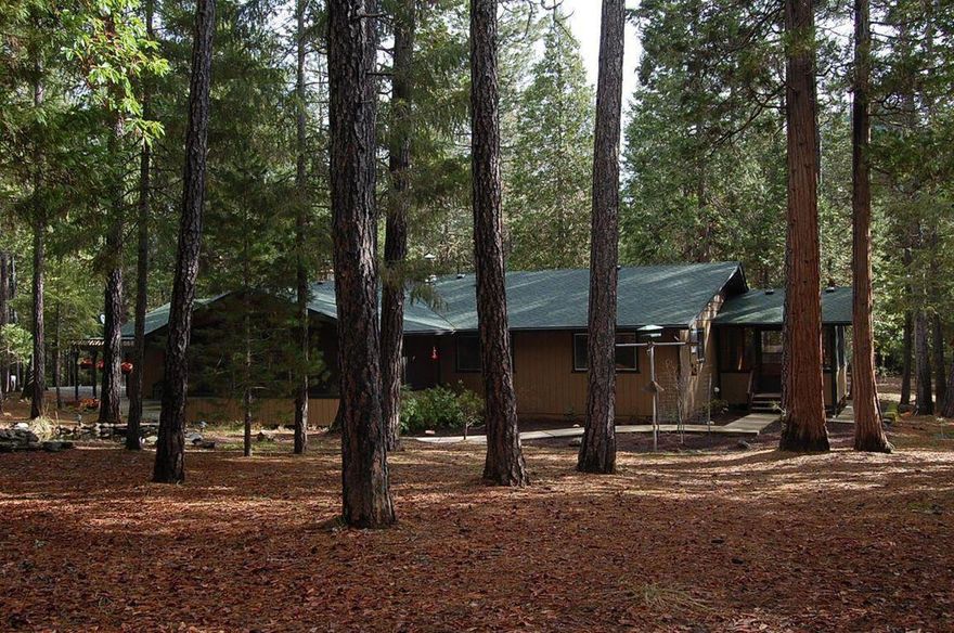 This wonderful country home has had many upgrades in the past few years --- roof, carpet, paint, 2 wonderful enclosed patios that are like rooms, new appliances, remodeled kitchen, remodeled baths with tiled showers and cast iron tub and shower pan, electronic blind in the living room, french door with in glass blinds, park like natural grounds, water feature can be viewed from the enclosed back porch. The attached two car garage is finished and insulated. Really nice wood shed that could be used as carport for equipment. Drip system to the flower beds. Fenced area for pets or garden. You will really enjoy the comforts of this country home.