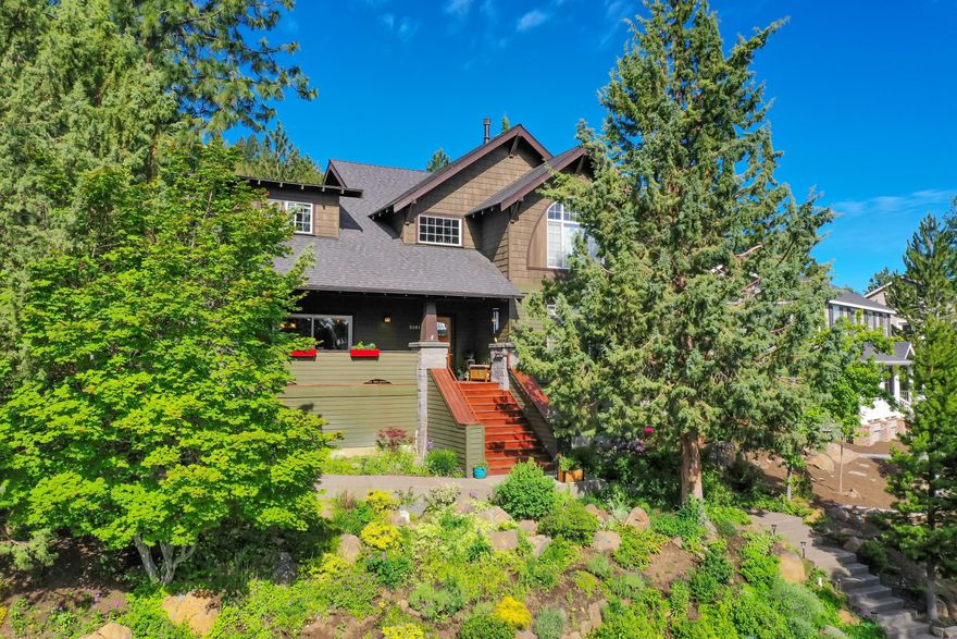 This Awbrey Village 3,161 sqft home delivers Craftsman style interior detail and character, w/ large rooms and open concept. Front steps wrap around a butterfly garden leading up to a full-length front porch w/ mountain views. Living features include a primary bedroom on the main w/ fireplace and newly remodeled en suite, a place to relax from any day. An additional bedroom on the main level provides flexibility for a guest room or home office. The updated kitchen, living and dining area are w/ open concept for easy family living. Upstairs presents two add'l bedrooms, full bath, large laundry, and a generous multi-purpose great room w/ vaulted ceiling. A lush and well-maintained landscape offers outdoor retreats: front porch view of East Bend and the Ochocos, quiet hammock hideaway and a back patio w/ dining space and hot tub held in a fenced backyard. Recent kitchen remodel w/ newer appliances, oversized 2-car garage, and detail to property maintenance delivers excellence. A MUST SEE.