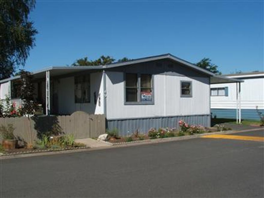 Priced for quick sale! 3 Bed/2 bath home in Medford Estates. Home sits on a great large lot in park. Fenced front entry in addition. Space rent includes water, garbage & sewer. Park has rec room, pool,fitness center & additional parking available at minimal cost for RV's, boats, etc. Home needs some TLC & is priced to sell.