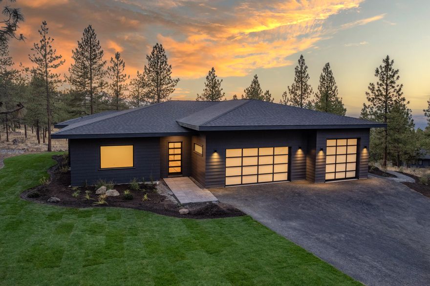Stunning NW contemporary perched on a gently sloping lot atop the west flank of Awbrey Butte – this new construction home has been painstakingly planned with an emphasis on natural light, welcoming spaces and thoughtful interior selections. 3435 sq ft spread across one level, an expansive west-facing deck with custom firepit overlooking the Cascade Mountains and a sea of towering pines.  The 971 sq ft, 3-car garage features an oversized single bay with 10'x10' door and 12' ceilings. The light-filled interior of the home with 10' ceilings is centered around the great room and expansive kitchen with quartz countertops and Thermador appliance package. The luxurious primary bedroom suite on the north end of the home is separated from the two guest bedrooms which are nestled behind a media room in the south wing of the home. A spacious office off the entry, a large walk-in pantry and laundry plus abundant storage throughout round out this stunning home slated for completion in fall 2022.