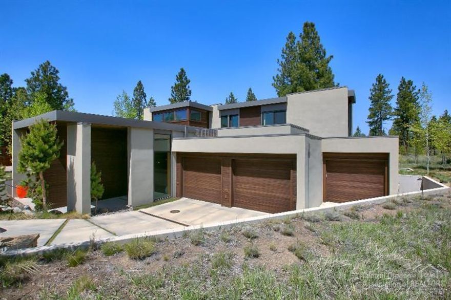 Formidable construction tucked into the earth. Designed by international firm, PIQUE, and lovingly constructed by renowned builder, R. Strauch. Exquisite example of modern architecture rests in the select community of Shelvin Commons which is approximately 3 miles from downtown Bend and contiguous with Shevlin Park. Expansive indoor and outdoor entertaining venues. Three top floor en-suite retreats. Two offices. Roof deck. Gourmet kitchen. Rooftop panels collect the sun and radiate heat through the home.