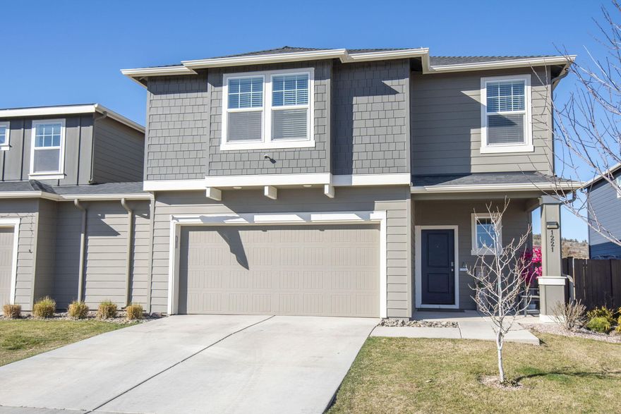 A 2.7% ASSUMABLE LOAN and a $7800 interior paint allowance make this home a winner! This is living at its best. The HOA takes care of the front lawn and the exterior paint and roof, so you can simply enjoy the huge 40' x 85' entertainer's dream yard with two large pergolas that have electrical and TV hookups. This well-maintained home is conveniently located one block from Tom McCall Elementary and has easy access to Hwy 97. The inside is spacious with tall ceilings, lots of space, a large flex room and a beautiful open kitchen that looks out to your backyard.,  Quartz countertops, gas range, white cabinets, and SS appliances are a few of the features you will enjoy. Lives like a single family home with just a small garage wall that connects neighboring unit.  This property is a must see and offers so much more than you would expect.. Make your appointment to see it today!