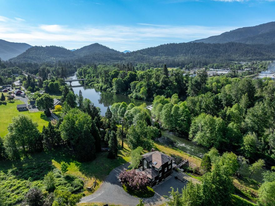 Beautifully custom-built home on the scenic Applegate River, offering 2,437 sq ft of thoughtfully designed living space with 3 bedrooms and 2 baths. Built in 1995, this riverfront retreat features expansive windows that showcase breathtaking 365-degree views year-round. Relax on the newly completed back deck as the river flows by, or enjoy the updated entryway with new front steps, balcony, and entry door. The property is rich with unique features, including a small water tank swimming pool, a serene treehouse yoga/meditation retreat, and a charming guest house. Sustainable living is made easy with new solar, stand-alone generator, and a drive-thru garage. Additional highlights include a picturesque pond, chicken coop, and raised garden boxes—ideal for those seeking peace, privacy, and self-sufficiency in nature's paradise.
