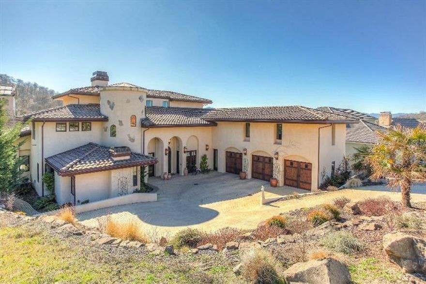 Close distance to Prescott Park from this exquisite, architecture designed Mediterranean home. This 5750 sq. ft. home exudes quality w/ a grand great room with massive beams & clearstory windows that provide ambience & light. The courtyard w/ a large screen TV & onyx surround fireplace flows from the main floor area to a travertine stoned backyard & seasonal creek. For the cook/entertainer, the kitchen has SubZero/Wolf appliances, 2 dishwashers & walk in butler's pantry with SubZero wine refrigerator. The cozy separate office has a stone fireplace. Pamper yourself in the main floor master w/fireplace, sitting areas, heated bathroom floors, a Jacuzzi Air Tub, travertine slab vanity, large closet & laundry room. Walk up the circular staircase to 2 additional bedroom suites, a 2nd laundry & a theatre/gym/home office with kitchenette. Away? No problem. Turn on/off audio, lights, adjust temp, open/shut oversized 3 car garage from your smart phone. Complete w/ secure video surveillance.