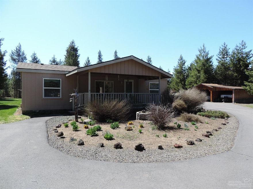 Fantastic, well-kept home on quiet acre has out-buildings enough to suit the Gardener & DIY-er! Great Deck & landscaping, in-ground sprinklers, garden shed, raised beds w/deer fence, greenhouse & storage for all your equipment & toys! New ext. paint on home, other painting to be completed. Cert. Woodstove, all appliances incl., covered front porch, asphalt driveway, maintained roads. Garage has attached 1 BR/BA apt. for guest, tenant or caretaker. Home has been equipped with ramps for wheel-chair access.