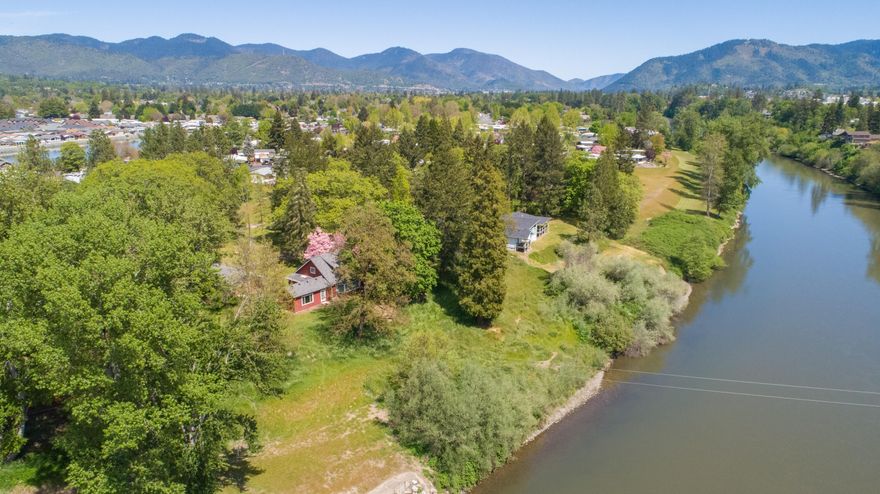 Finally The Easy Access Riverfront Property on 2.53 Useable Acres You Have Been Waiting For!  Charming 1930's Farm-Style two story 2,830sf home with primary bedroom on main floor with separate, dual access primary bathroom and door out to river-facing patio. Two Jack-and-Jill bedrooms (both connect to bathroom) upstairs.  Nice cozy fireplace in living room. New carpet in most areas, new main roof, gutters & downspouts! Clean & ready to move in! Home has mesmerizing river view windows throughout. Detached workshop w/half bath & attached carport. Separate and spacious storage shed.  Area with room to fence for animals. Circle drive. Areas to park RV and other recreational vehicles.  Sits back off the main street (Lower River Road) at the end of Summer Lane for privacy from most of the world (can see neighbors though).  Very nice neighborhood and close to town.  This home and property checks the boxes at a price to leave room for future updates & personalization! Book your Showing Today!