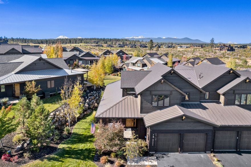 Elegance meets sophistication in this stunning Triple Knot townhome. A coveted location overlooking lush greenspace and not one, but two idyllic ponds along with Cascade views. Appointed with all the amenities you'd expect including modern cabinetry and stunning hardwood floors. On the main level you'll find a primary suite, office, laundry, and great room with a handsome floor to ceiling fireplace offset by generous windows and warm wood beam accents. There are two additional suites upstairs, the south suite offers awesome Cascade views while the east captures the first morning light. The primary patio is adjacent to a lovely pond in full display of fall colors. This is truly an exquisite home in an exceptional location.