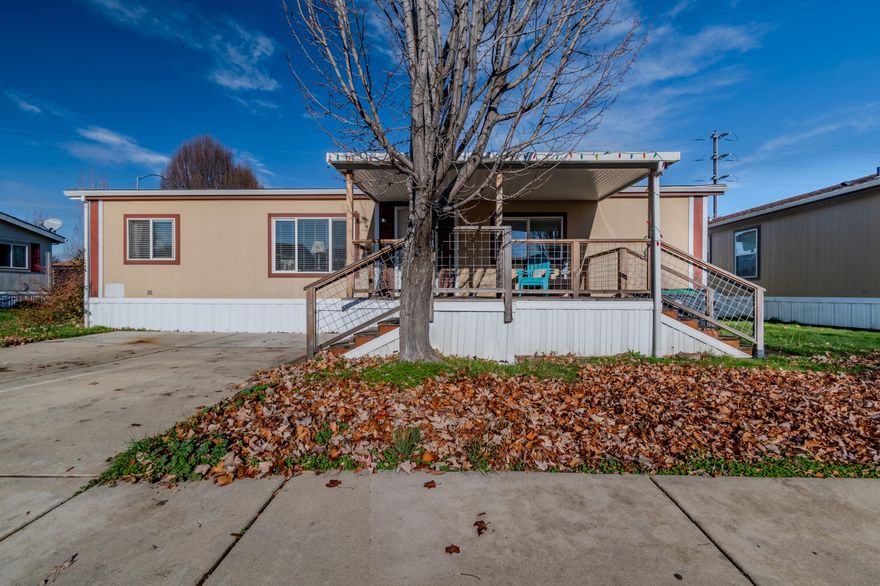 This is a move-in ready well-cared for home with an open floor plan. The kitchen features tiled counters, stainless appliances, pantry cupboard, a breakfast bar and adjoining dining area.  The open floor plan provides ample living space, vaulted ceilings and engineered flooring. Primary bedroom has vaulted ceilings, the en suite has a garden tub/shower making it a perfect retreat. The other 2  bedrooms and guest bath are on the other end of the home. The front entry has a large covered deck. Nice sized back yard with no homes behind it and a shed for extra storage. This home is in an all age community park with many amenities including a pool, gym, park and  clubhouse. Close to shopping and dining.