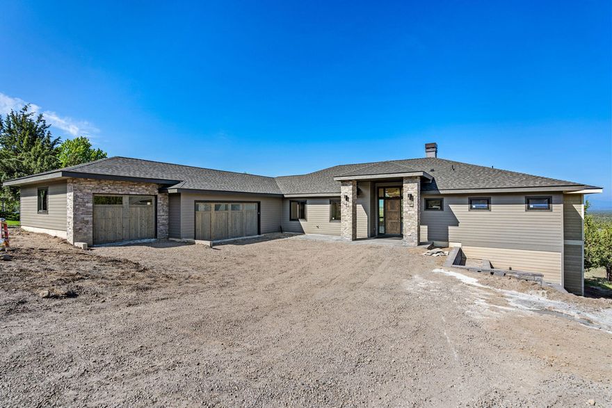 Gorgeous custom home in Eagle Crest Resort is nearing completion! This prime location on the West Ridge offers breathtaking views of the Cascade Mountains and easy access to BLM trails, Cline Buttes trailhead, and the Lakeside Sports Center. The open-concept floor plan features 2955 square feet with two primary en suites; one with a free-standing soaking tub and one with a walk-in shower. An additional guest room, full bath, office, bonus room/tv room, a half bath, and a utility room complete this fantastic single-level floor plan. This home is finished with black framed windows inside and out, hand-troweled walls, solid quartz counters in the kitchen and all bathrooms, and engineered hardwoods everywhere except the bedrooms. 1283 sq ft triple-car garage with three doors and a partially covered west-facing deck. 12 x 15 Sq Ft finished storage room under home.