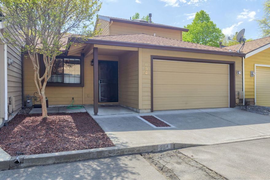 Come check out this  comfortable and cozy home. It has just the right amount of space and conveniently located to everything that is East Medford! This home offers individual privacy with the primary suite downstairs and second bedroom and bath upstairs. Clean and move-in ready with fresh paint in the living room, vaulted ceilings, new dishwasher, newer HVAC system, finished one car garage with workbench and shelving, freshly cleaned gutters with leaf guards, you won't have to do a thing!  The back patio is private and spacious with Trex decking and even a garden bed! NO HOA!  Call to see this home today!