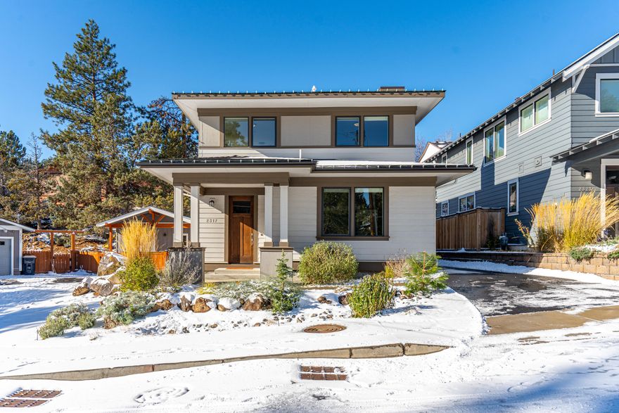 Perched just blocks above First Street Rapids, the Deschutes River Trail & less than a mile from Downtown Bend, this turn-key house is like new and ready for you to call home. Natural light floods the open concept main living area with a cozy gas fireplace, easy access to multiple outdoor living spaces and an absolute dream of a kitchen. With expansive quartz counters, abundant cabinetry for storage and plentiful windows, this a marvelous place to create your next culinary masterpiece while friends and family gather around the oversized kitchen island with bar seating. Enjoy the ease of main-level living with both your home office & a generous primary suite with an oversized closet. The recently added outdoor entertaining patio is a true gem, including corten metal retaining walls, new fencing, mature landscaping for privacy & space for all to gather. This property is perfectly positioned to be your next home base & the optimal launch pad for all your Central Oregon adventure.
