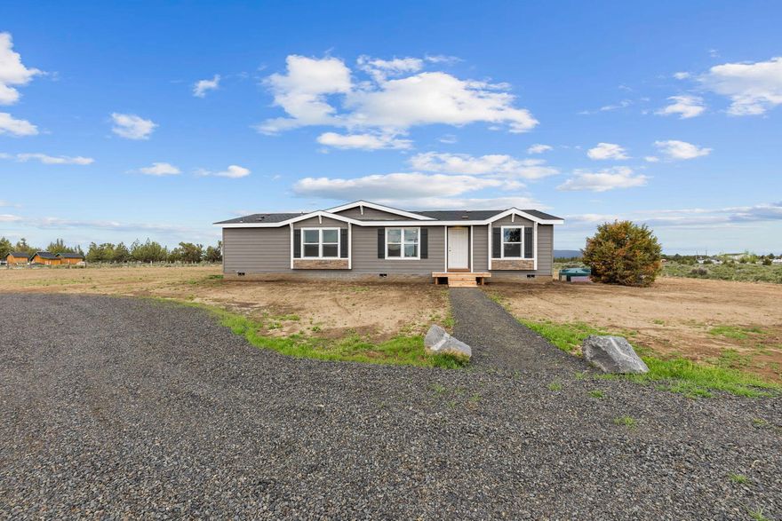 Enjoy the stunning Cascade Mountain views from this brand new home on 1.83 acres. Backs up to thousands of acres of BLM land. Ride quads, dirt bikes, or
horses right out your back door. Home is located at the end of PLA2 just minutes from Prineville Reservoir & a short 15 min. drive from the City of Prineville.
Community has paved roads, community water & tons of privacy. The living room is spacious & open w/vaulted ceilings, lg bright windows & ceiling fan.
Home is 1,512 sq ft, has 3 large bedrooms and 2 full baths. Stunning kitchen w/propane stove, refrigerator, dishwasher, an incredible amount of counter space &
quality cabinetry. Off the kitchen is a massive pantry w/room to use as hobby space or office. Laundry room is plumbed for electric or propane & has cabinets &
utility sink. 400 amp service w/room to add a shop & seller will include a set of shop plans. Round about driveway for easy turn around & parking.