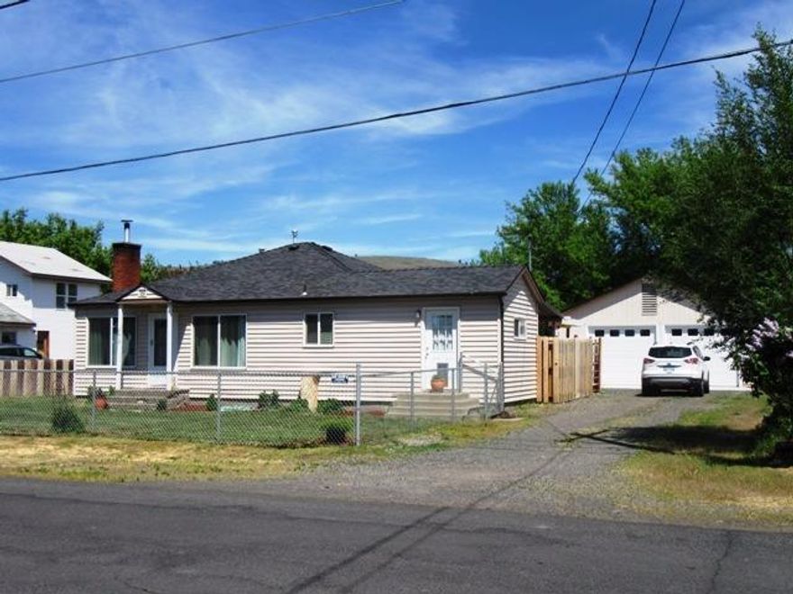 Charming 2 bedroom 1 bath home on almost 1/3 acre. Over size 2 car garage is 832 sq ft-deep would probably hold 4 cars tandem. Updated bathroom in neutral colors . Certified wood stove and gas furnace are fairly new. Kitchen has lots of cabinets& counter space with room for a full size table. Large laundry/utility room. Hardwood flooring in living room & bedrooms.fenced front & good sized backyard. No showings till June 6th.
