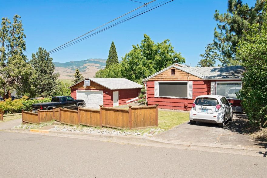 What an opportunity! Remodeled, charming single-story residence located in one of Ashland's desirable historic districts, just a few blocks from the Plaza and downtown This 3 bedroom, 2 bath home with covered patio access your private and stunning backyard. Detached 2-car garage has upgraded electrical, work-benches and pull down attic stairs. Two driveways (one with electric car charging station) and surrounding mountain views. All that is missing now is you! Property is zoned R-2 for potential development into 2-3 new units. It's also large enough to be split into 2 separate lots by future owners (verified with City of Ashland property can be split into two 5880sqft lots). Ask your agent for more details on upgrades. Helman School District.