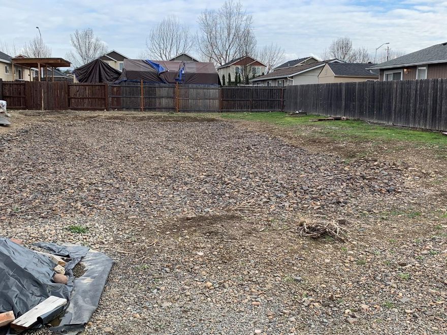 This lot sits on a small street surrounded with newer construction in the eastern part of White City. Utilities are at the property line or on the lot, fenced on 3 sides, and some excavation has been completed along with Shale rock installed. Bring your builder as this lot is ready to go. 60' wide street side X 100' deep.