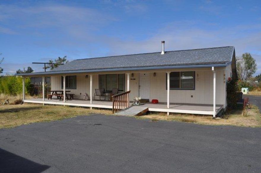 Wow 2 homes on a large lot! Main home is custom built for owner with nice front porch. 3 bdrm/2baths 1626 sq ft with vaulted ceilings, skylights, great den/office. Nice kitchen with dining room to a large covered patio. Great family room plus living room. Second home is above the 2 car garage with large open trex deck over looking a field with 2 bdrm 1 bath, 576 sq ft full kitchen and living room. 2 Car garage with toilet plus 2 carports. Paved flag lot offers tons of parking. Tons of potential for additional buildings on property buyer to do due diligence.