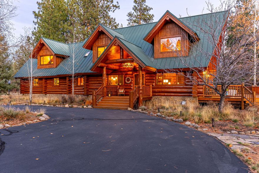 Beautiful log home on 5.62 private acres just minutes from downtown Sisters and public lands. Enjoy manicured landscaping surrounded by ponderosa pines and aspens. A covered porch welcomes you to a four-bedroom home featuring an open floor plan with a 30' vaulted great room, soaring windows, and a floor-to-ceiling stone fireplace showcasing warmth and craftsmanship. The updated entertainer's kitchen opens to a wrap-around cedar deck with a hot tub and private sitting areas. Upstairs offers a loft/sitting area, spacious primary suite, two bedrooms, and a full bath. The finished 1,152 sq ft basement includes a family room and storage. Two large garages, a professional woodworking shop, heated tack room, and loafing sheds complete this remarkable estate—perfect for horse enthusiasts and those seeking privacy with luxury.