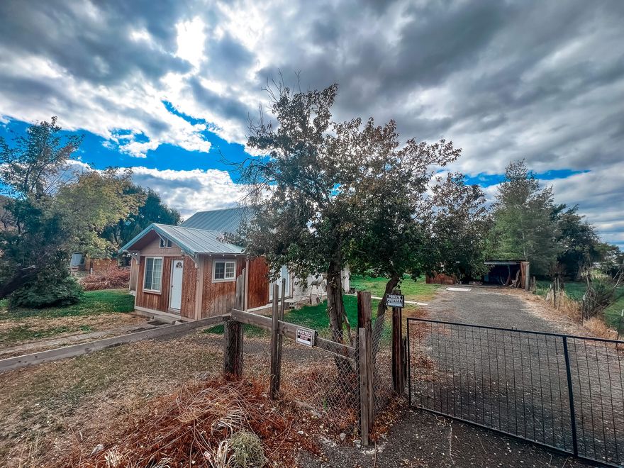 Put the final touches on this property, a 1900s home featuring 1,203 sq ft on the main level and an additional 336 sq ft upstairs. It includes three bedrooms, an office (which could serve as a non-conforming fourth bedroom), and two bathrooms (2nd bathroom is currently being renovated). Updates throughout the years have been made to the insulation, plumbing, electrical system, sheetrock throughout, and it boasts vinyl windows and doors.

The impressive 0.36-acre lot is completely fenced and features multiple fruit trees along with an irrigation well. Additionally, there is a 24' x 30' carport with a workshop, a 16' x 16' shed that includes an 8' x 16' section with tile flooring and sheetrock, an 8' x 30' shed, and a 10' x 10' shed that could serve as either a chicken coop or storage space. Come explore all that this property has to offer! Flood Plain. Sold as-is.