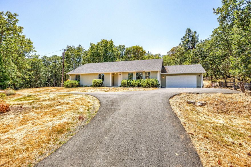 Country Living Yet Minutes to Grants Pass.  This North Valley home is situated on 1.62 acres, was built in 2007 & features 1920 sq ft, 4 bedrooms, 2 full baths, open floor plan, vaulted ceilings & an abundance of windows make it light & bright. The kitchen has been updated with granite countertops, island, wine frig & nice pantry.  Nice primary suite with shower & granite counters and the additional bedrooms are nice sizes.  Exterior features include 2 car attached garage, paved, circular drive and gated entry.  The yard is a blank slate, waiting for your creative ideas!  Is this YOUR new HOME?!