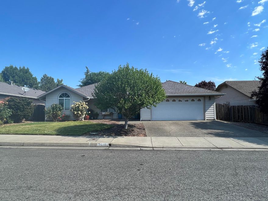 Location, Location, Location! This Charming home sits on a .19 acre lot and features an open concept with a split floor plan and vaulted ceilings. The primary bedroom has its own hallway and entrance to the back patio along with ensuite bath and a large walk in closet. The Kitchen is equipped with higher end appliances, lots of counter space, cabinet space and a separate pantry. Secondary bedrooms are good sized, separated by a full bathroom. The spacious back yard is fenced and has a shed that can be utilized for what ever you need. Situated in a newer subdivision close to schools, shopping, hospital, and medical facilities and only minutes from downtown Grants Pass, this is a must see. Call now to make your easy appointment to see this gem!