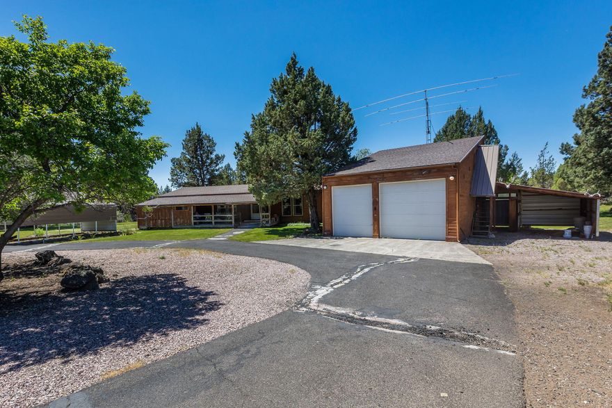 Come and experience the peaceful country living in Los Serranos neighborhood! This rustic property is located near Bend's city amenities and sits on 3.70 acres with 2 acres of irrigation water rights. The home features 3 bedroom, 2 bath with 1322 SqFt of living space, vaulted tongue and groove ceiling, under cabinet lighting, stainless steel appliances, tile countertops, pantry, pellet stove, air conditioning. Outside you will find front & back covered deck, huge greenhouse, detached 2 car garage with workshop and storage/bonus room upstairs, covered carport, asphalt driveway. Sold As-Is! This property offers the ideal blend of rustic charm and modern amenities, providing a peaceful retreat with all the conveniences of city life nearby. Don't miss out on this opportunity to call it home!