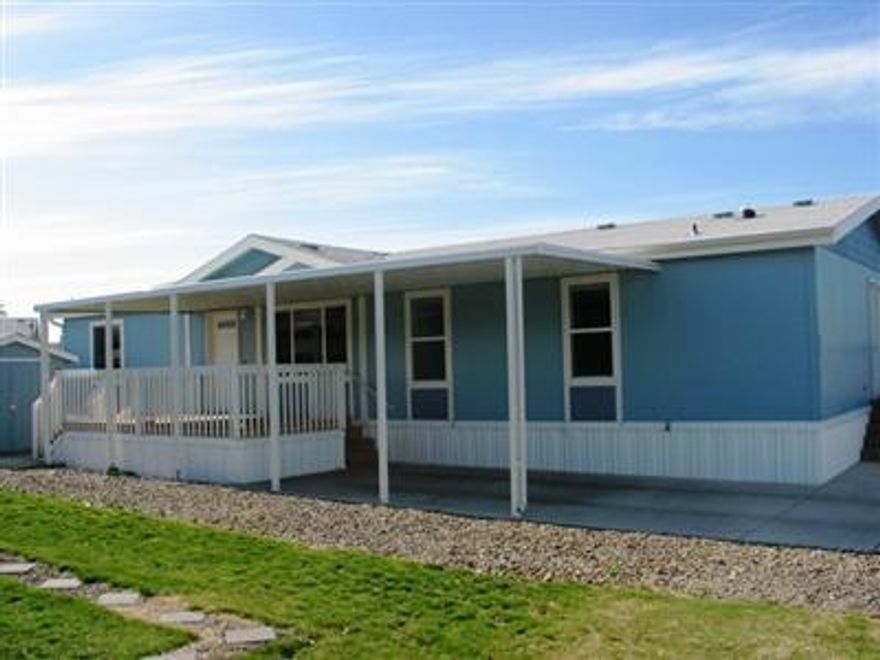 Very nice 4 bedroom, 2 bath home in a great park. This custom made double wide manufactured home built in 2004 is in excellent condition. The home has 1566 square feet of living space and a great open floor plan. Upgraded light fixtures and upgraded carpet throughout. Ceiling fans in almost every room and Sola-tubes in both bathrooms and kitchen. Refrigerator, range/oven and dishwasher are included. large covered deck and covered parking under the attached carport.