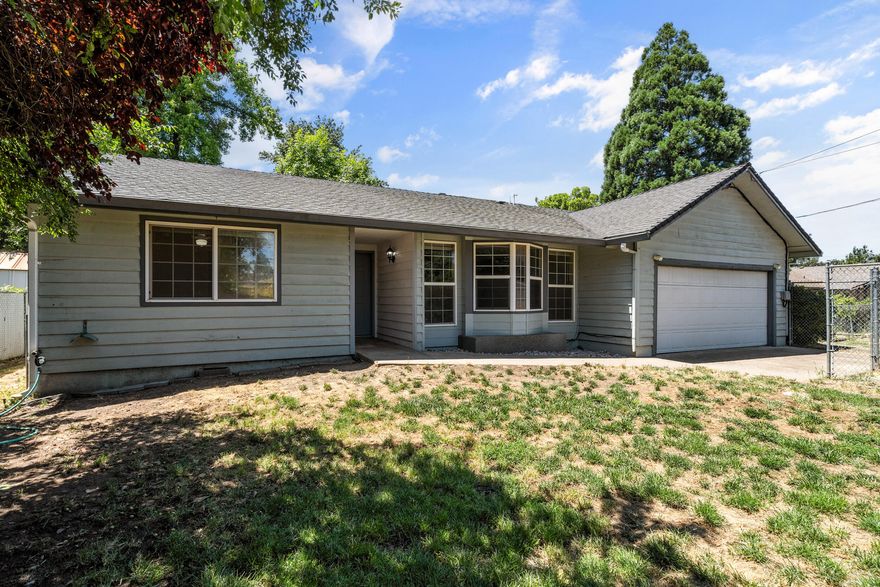 Opportunity awaits new owners needing space and flexibility! Located in the desirable Oak Grove school district, this home sits on a large, private lot with two fenced yards—perfect for pets. Plenty of room for RVs, boats, and extra parking. Inside, you'll find a newer high-efficiency gas furnace & A/C, a cozy gas fireplace and a versatile layout including a second living room that could be a 4th bedroom. A 200 sf garage conversion has served as a playroom, guest space, or storage. Possible ADU (up to 1,269 sf—buyer to verify) offers great multi-generational living or rental income potential. Just 3 minutes to South Medford High. Come see all this home has to offer!