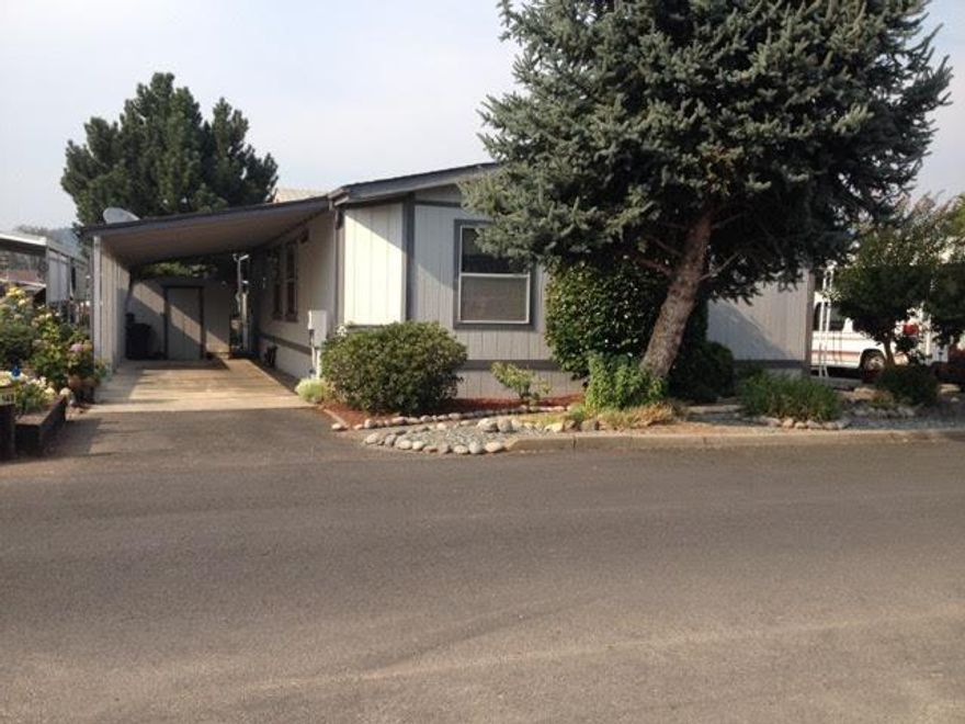 Relax and Enjoy! Water front location in 55+ Rogue Lea Estates. This 3 bedroom / 2 bath Fleetwood Manufactured home has 1568 square feet. Custom built in 1990 with only 1 owner, this beautiful home offers many features including a newer heat pump, walk-in closets in all bedrooms, and a separate laundry room with washer and dryer included. Natural light abounds. Landscaped front and back yard areas with stepping stones to pond front.