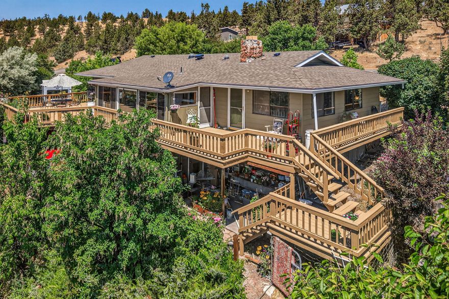 Overlooking the lush farmland and rimrock ridges beyond, this charming and updated 2bed, 2.5bath home offers a perfect mix of peaceful country living and modern convenience. Set on a combined .72 acre triple lot, the property provides space, privacy, and stunning views - just minutes from town. Inside, enjoy a light-filled layout with 2 full baths on the main level and a convenient half bath in the daylight basement - perfect for guests, a hobby room, or added flexibility. Recent upgrades include a new roof in 2021, newer garage door, updated deck, newer heat pump. An attic exhaust fan adds extra cooling. Installed backflow valve at the street protects your water system. Step into the enclosed sunroom year round. Enjoy the spacious yard with mature fruit trees, flowering plants. RV parking with full hookups. Whether you're gardening, relaxing on the deck, or watching the sunset, this home makes it easy to love where you live. Move-in ready, beautifully cared for and full of features.