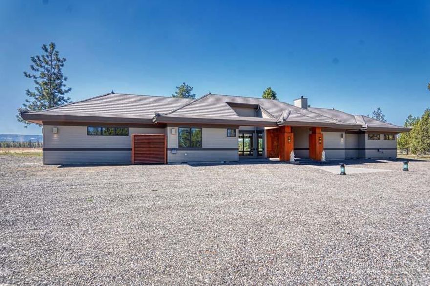 Ranch living without the ranch. Exquisite, like new Balinese style luxury home on 2.5 acres. Fantastic mountain views overlooking farm land. Enjoy the light and bright central great room with top line chef's kitchen, large dining space and living room featuring dramaticvaulted ceiling, cathedral window wall and cozy woodstove. Two master suites on either end of the home. Spacious paver stone entry and rear patio for easy outdoor enjoyment. Natural landscaping for ease of living. Small attached single garage plus large 36'x42' detached garage/multi-purpose building.<br>