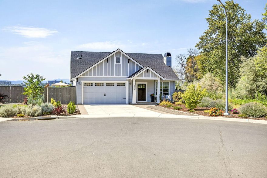 Better than new, this 2022 Pacific Trend built Craftsman home offers exceptional quality in a peaceful, end of cul-de sac-setting. Located w/ a riparian corridor & bioswale on 2 sides & only 1 neighbor, you'll enjoy privacy & quiet while still being steps from a public bike path for easy recreation. Expansive windows bring in natural light & frame beautiful mountain views. Inside, the open floor plan features a gourmet kitchen w/ granite counters, tile backsplash, & custom birch/alder cabinetry. The open living area includes a tile fireplace & vaulted ceilings, w/ luxury hardwood flooring throughout most of the downstairs. The primary suite is conveniently located on the main level & features an en-suite bathroom, as well as slider access to the hot tub. The bathrooms & laundry have tile floors. Upstairs, there are 2 additional bedrooms & a full bath. Outdoors, low-maintenance landscaping surrounds several paver patios along w/ your own putting green, perfect for entertaining.