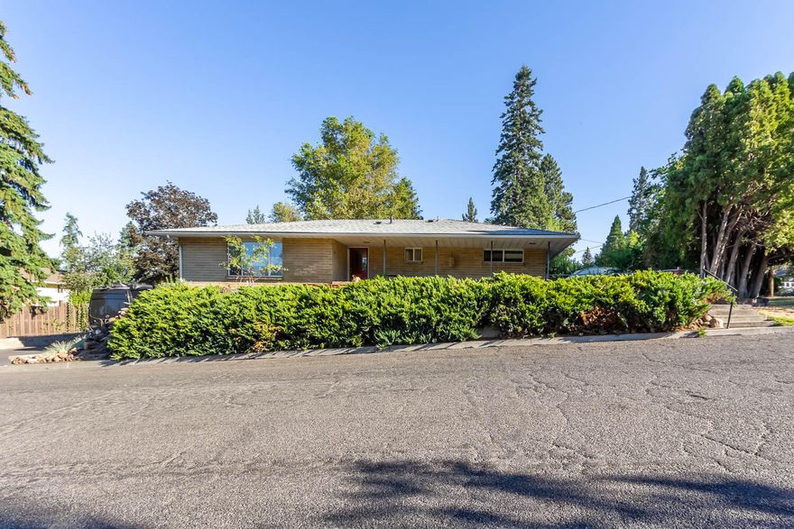 Nestled at the base of Pilot Butte, you will  find a hidden gem located at 1201 NE 9th Street.  An updated 1953 mid-century modern brick home on a corner lot with much to offer!  The updated, entertaining kitchen is a chef's delight!  Equipped with a professional 6-Burner Viking stove, warming lights & industrial hood; live edge floating shelves, new LG Appliances, granite counter tops, butcher block peninsula, lots of storage and a built-in kegerator!  Enjoy many other features such as the hydronic radiant heat flooring throughout, multi-zone wired Sonos system, central vac and new LVP flooring!  Extend the comforts of the home to the outdoors where there are multiple areas to entertain, including the freshly painted back deck, or sit and enjoy 4th of July fireworks from your front porch! There is also dedicated RV parking & hook-ups.  Exterior faucets offer both hot/cold options.  Rounding out all this home has to offer is the finished mother-in-law suite or possible ADU opportunity!