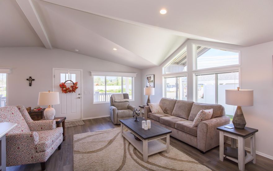 OPEN for admiration! This beautiful, almost new Skyline 3 bedroom, 2 bath home is just the right size if you're looking for 2 bedrooms plus an office. Vinyl plank floors throughout the house make cleaning a snap. The large main bedroom suite runs across the back of the home. There is a double vanity, step-in shower, linen closet & extra storage in the bath. The kitchen & living area are in the front with views of the neighborhood & hills. There are plenty of counters & cabinets dressed in stylish grey paint & large center island to please the cook.  A large front porch is perfect for day dreaming & watching the world go by. You've got a shed & plenty of space for your cars under the carport. A stone walkway around the backyard, a covered side patio for BBQs & artificial turf keep the grounds neat & tidy. One small pet up to 25 lbs is allowed. There's a brand-new dog park & mailbox kiosk with parking at the entry to the park.  Once you visit, you'll want to move in.