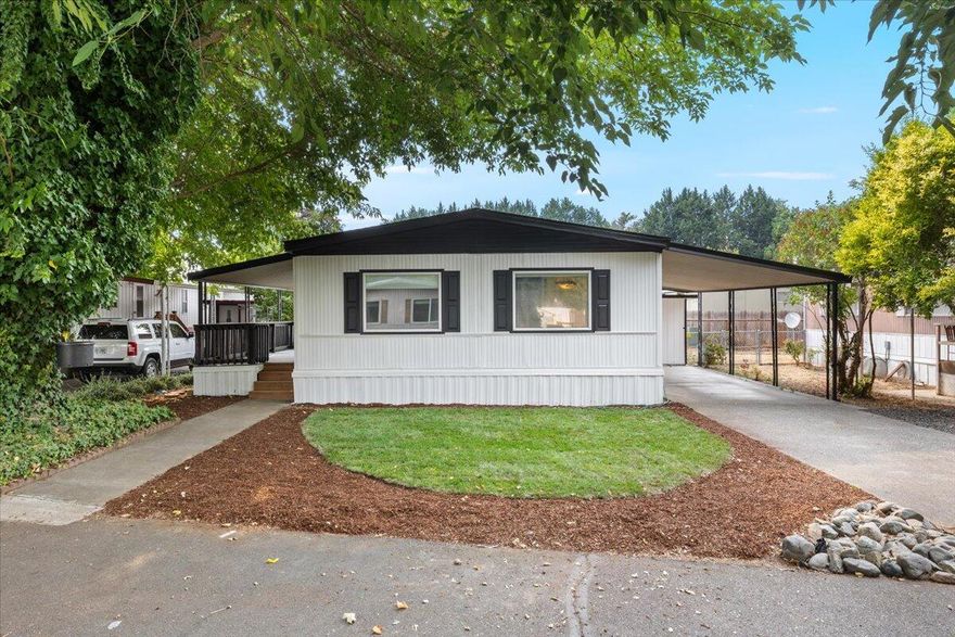 TONS of upgrades and updates make this home feel almost like new but for a fraction of the price! This move in ready 2 bedroom home features spacious walk in closets in both bedrooms and a bathroom with new flooring and a new toilet. Enjoy brand new carpet with padding, new flooring in the kitchen, dining, and bath, plus fresh interior and exterior paint that gives the home a bright, modern feel. Double-pane windows fill the space with natural light, and the new 2025 HVAC system keeps you comfortable year round. The roof was replaced in July 2025 with new plywood and high quality architectural shingles, and both sheds have new shingles and paint. All appliances are included, making it completely move in ready. Relax on the covered porch under a mature tree, enjoy your producing fig tree, and take in park amenities like a grassy pet area and a deck overlooking the Rogue River just steps away. With every major upgrade complete, this home delivers comfort & and peace of mind.